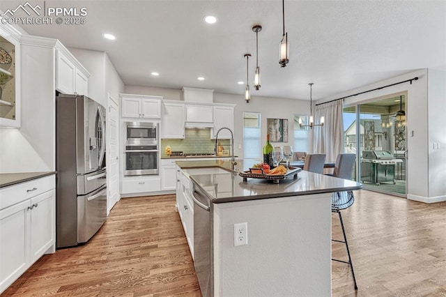 4464 Portillo Pl, Colorado Springs, CO 80924 - kitchen with appliances with stainless steel finishes, dark countertops, and light wood finished floors