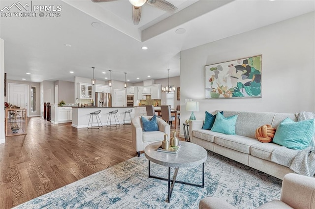 4464 Portillo Pl, Colorado Springs, CO 80924 - living area featuring recessed lighting, wood finished floors, and ceiling fan with notable chandelier