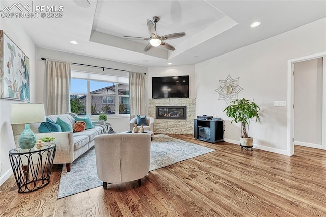 4464 Portillo Pl, Colorado Springs, CO 80924 - living room with baseboards, wood finished floors, a ceiling fan, and a raised ceiling
