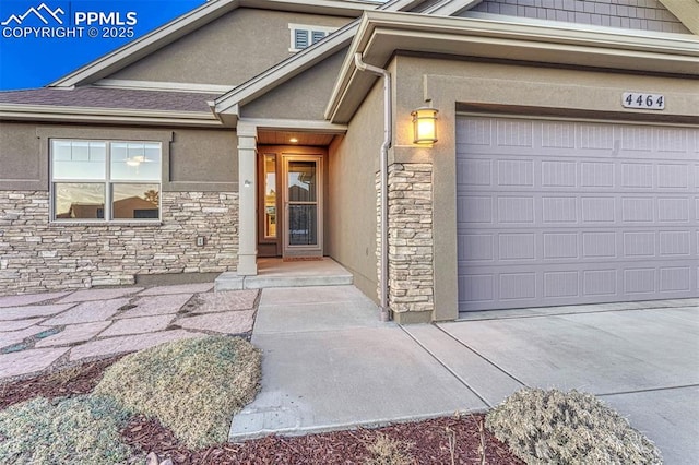 4464 Portillo Pl, Colorado Springs, CO 80924 - entrance to property featuring stucco siding, a garage, and stone siding