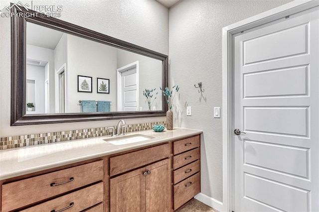 4464 Portillo Pl, Colorado Springs, CO 80924 - bathroom featuring baseboards, a textured wall, and vanity