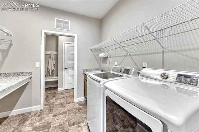 4464 Portillo Pl, Colorado Springs, CO 80924 - clothes washing area with a sink, visible vents, baseboards, washer and dryer, and cabinet space