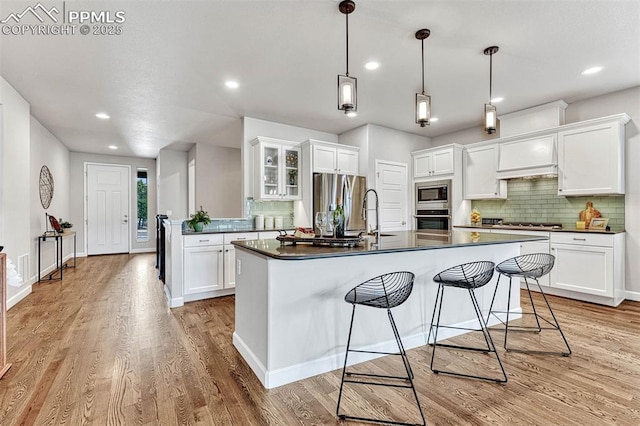 4464 Portillo Pl, Colorado Springs, CO 80924 - kitchen featuring dark countertops, a sink, backsplash, and appliances with stainless steel finishes