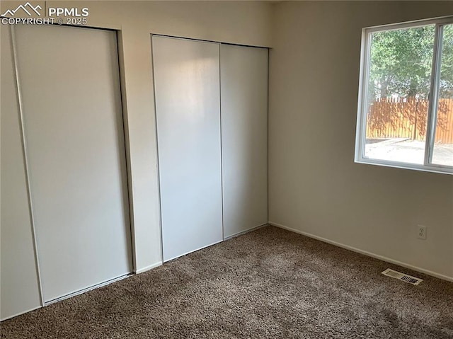 720 E Hills Rd, Colorado Springs, CO 80909 - unfurnished bedroom with visible vents, carpet, and multiple windows