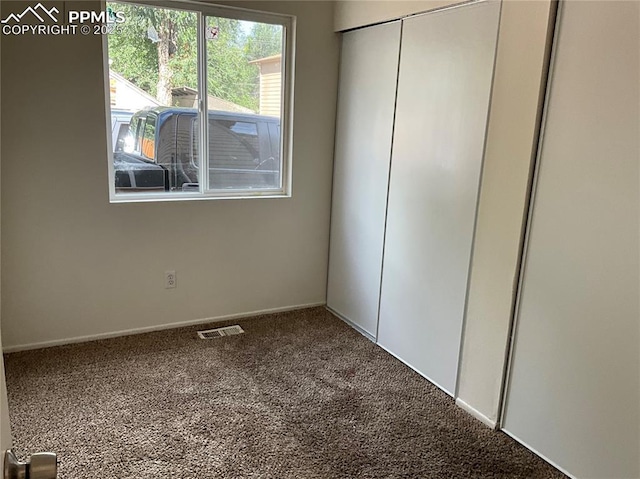 720 E Hills Rd, Colorado Springs, CO 80909 - unfurnished bedroom with baseboards, carpet flooring, visible vents, and a closet