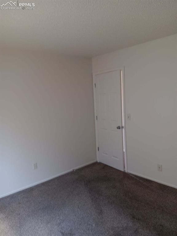720 E Hills Rd, Colorado Springs, CO 80909 - empty room featuring baseboards, carpet, and a textured ceiling