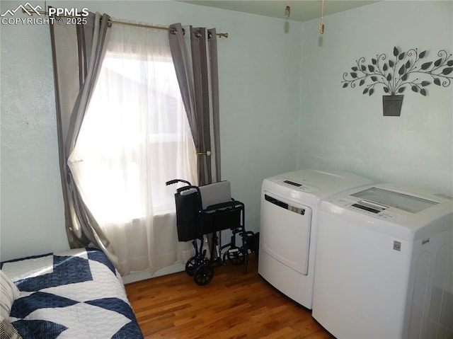 1007 Iowa Ave, Colorado Springs, CO 80909 - washroom featuring washing machine and dryer, a healthy amount of sunlight, wood finished floors, and laundry area
