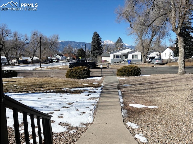 1007 Iowa Ave, Colorado Springs, CO 80909 - yard layered in snow featuring a mountain view and a residential view