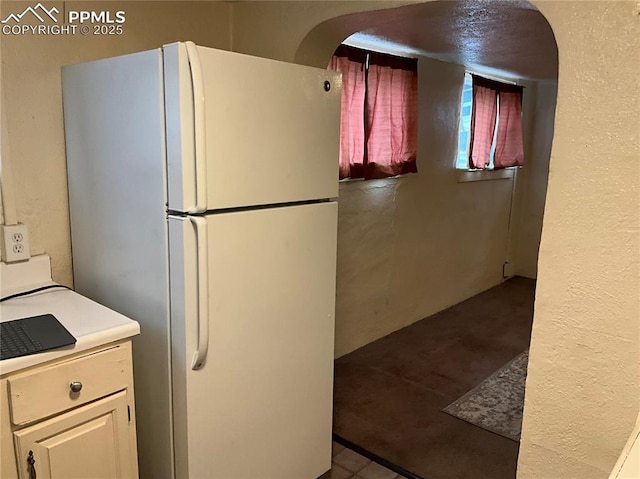 1007 Iowa Ave, Colorado Springs, CO 80909 - kitchen featuring arched walkways and freestanding refrigerator