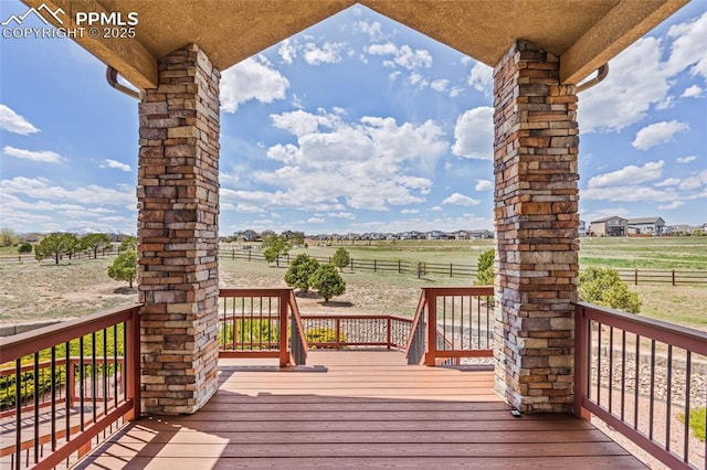 deck featuring a view of rural / pastoral area and fence