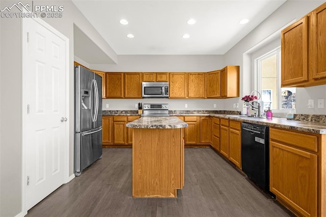 2261 Springside Dr, Colorado Springs, CO 80951 - kitchen with a sink, brown cabinetry, stainless steel appliances, dark wood-type flooring, and a kitchen island