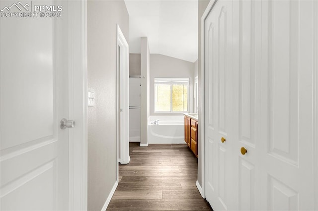 2261 Springside Dr, Colorado Springs, CO 80951 - hallway featuring baseboards, vaulted ceiling, and dark wood-type flooring