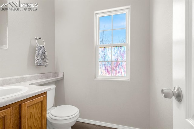 2261 Springside Dr, Colorado Springs, CO 80951 - bathroom featuring toilet, baseboards, plenty of natural light, and vanity