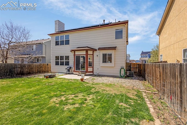 2261 Springside Dr, Colorado Springs, CO 80951 - rear view of house featuring a fenced backyard, a chimney, a yard, and a patio area
