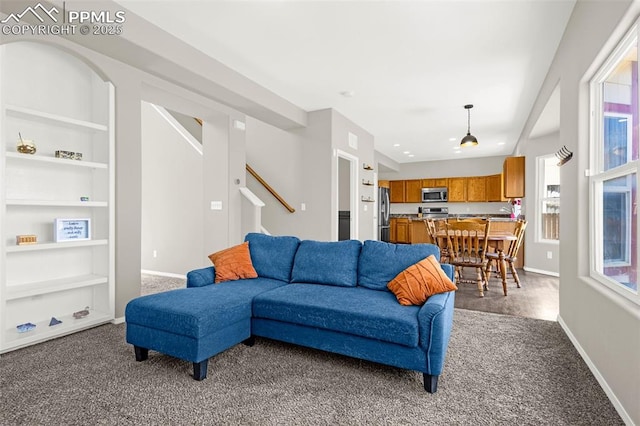 2261 Springside Dr, Colorado Springs, CO 80951 - living area featuring built in features, baseboards, carpet flooring, and stairs