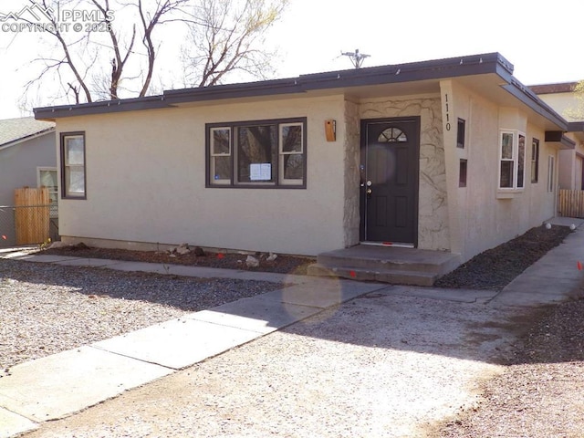 single story home featuring fence and stucco siding