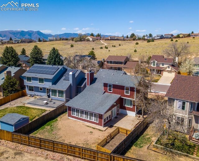 birds eye view of property with a residential view and a mountain view