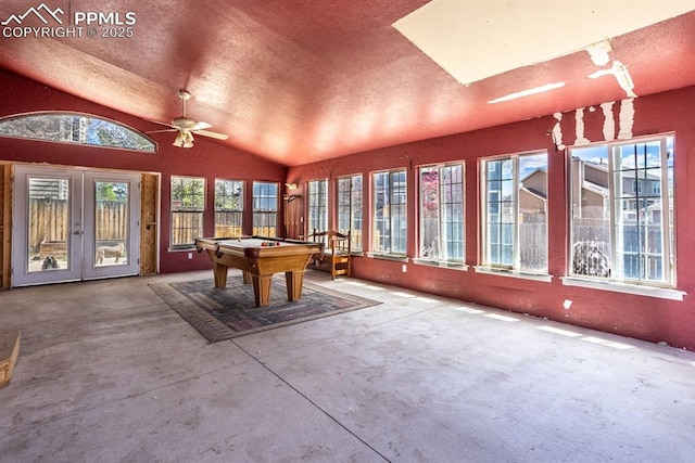 recreation room with lofted ceiling, unfinished concrete floors, a textured ceiling, pool table, and french doors