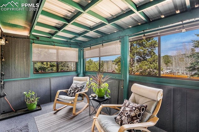 sunroom featuring a wealth of natural light and beam ceiling