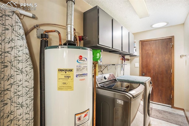 laundry area with cabinet space, a textured ceiling, gas water heater, and washing machine and clothes dryer