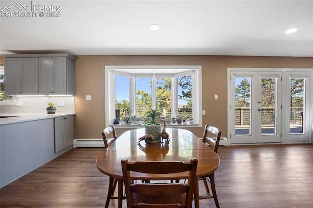 dining space featuring recessed lighting, dark wood-style floors, and a baseboard radiator