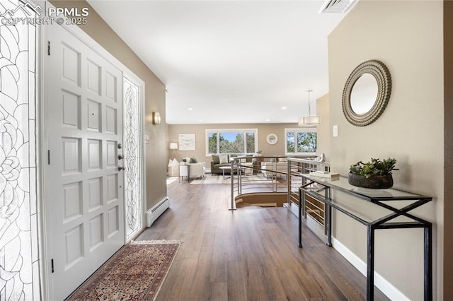 foyer entrance featuring visible vents, wood finished floors, baseboards, recessed lighting, and a baseboard radiator