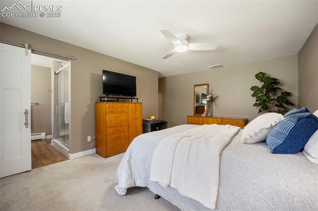 bedroom featuring visible vents, ceiling fan, baseboard heating, a barn door, and carpet flooring