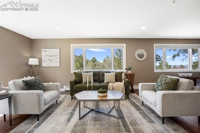 living area with baseboards, baseboard heating, recessed lighting, and wood finished floors