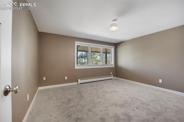 spare room with baseboards, a baseboard heating unit, and carpet flooring