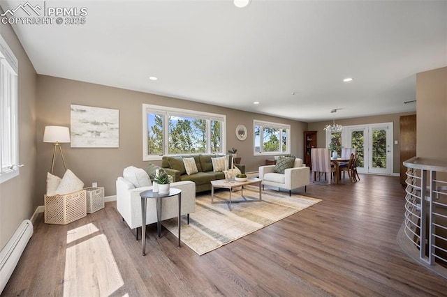 living room featuring recessed lighting, baseboards, a baseboard heating unit, and wood finished floors