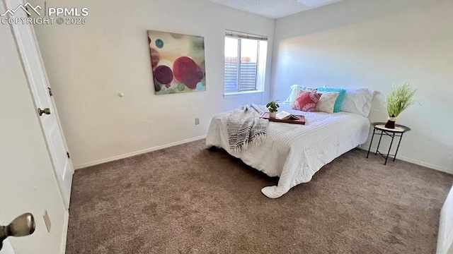 bedroom with baseboards and carpet