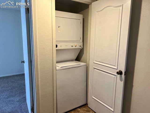 laundry room with stacked washer / drying machine, carpet, and laundry area