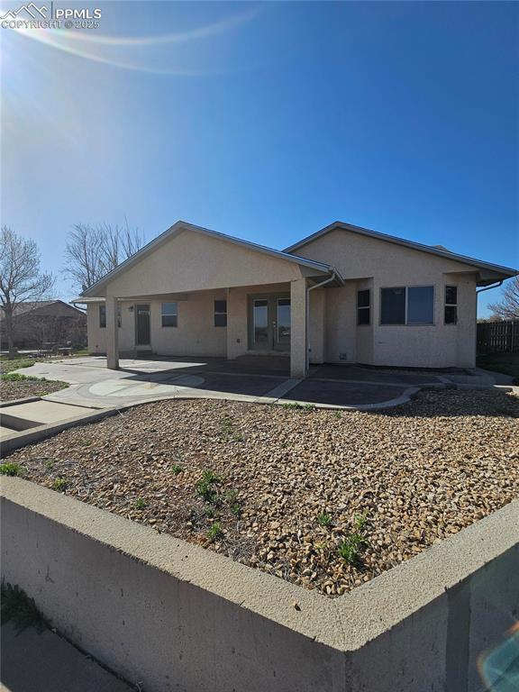single story home with a patio and stucco siding