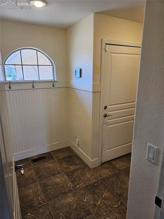 interior space with visible vents and wainscoting