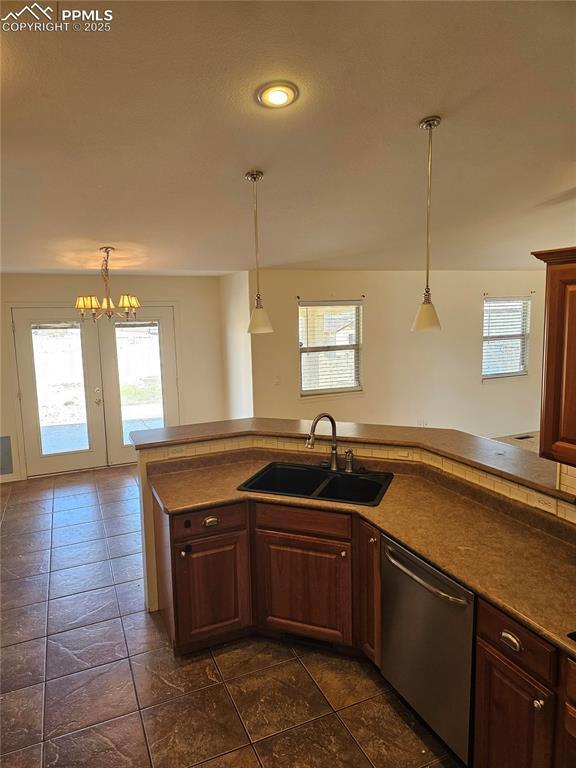 kitchen with dishwasher, a healthy amount of sunlight, and a sink
