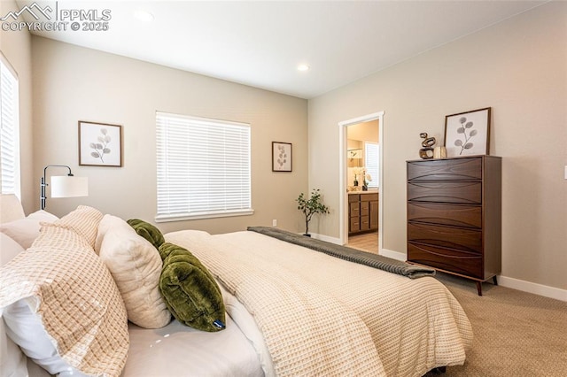 bedroom featuring light colored carpet, baseboards, recessed lighting, and connected bathroom