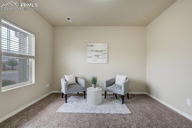 sitting room featuring carpet, visible vents, and plenty of natural light