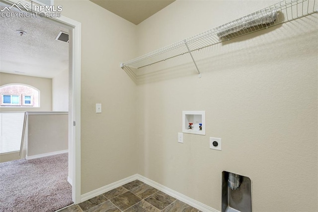 clothes washing area featuring laundry area, visible vents, hookup for a washing machine, baseboards, and electric dryer hookup