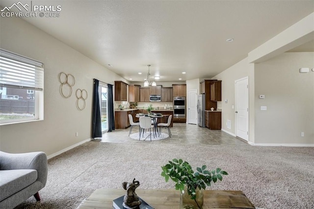 living area with baseboards, recessed lighting, a chandelier, and light colored carpet