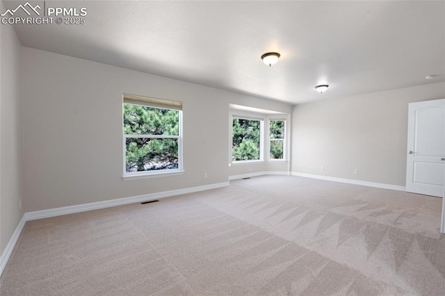 7436 Centennial Glen Dr, Colorado Springs, CO 80919 - spare room featuring baseboards, visible vents, and light colored carpet