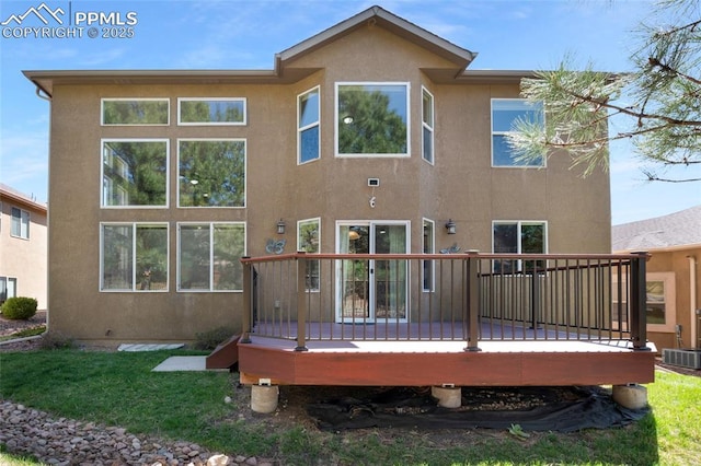 7436 Centennial Glen Dr, Colorado Springs, CO 80919 - back of property with a lawn, a wooden deck, central AC unit, and stucco siding