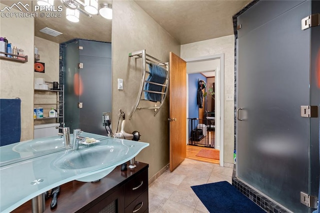 1514 Howard Ave, Colorado Springs, CO 80909 - bathroom with baseboards, vanity, and tile patterned flooring