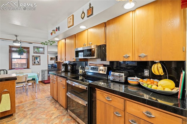 1514 Howard Ave, Colorado Springs, CO 80909 - kitchen with stainless steel appliances, tile counters, brown cabinetry, and tasteful backsplash
