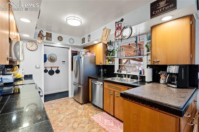 1514 Howard Ave, Colorado Springs, CO 80909 - kitchen featuring brown cabinets, stainless steel appliances, and a sink