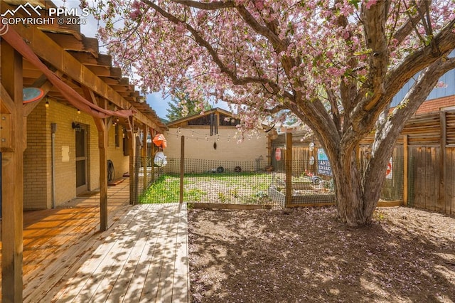 1514 Howard Ave, Colorado Springs, CO 80909 - view of yard featuring a wooden deck and a fenced backyard