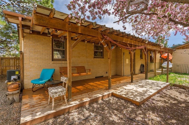 1514 Howard Ave, Colorado Springs, CO 80909 - view of patio / terrace featuring a wooden deck, central air condition unit, and fence