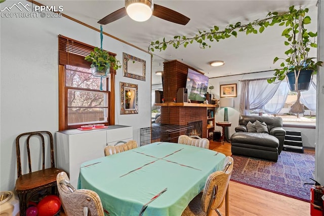 1514 Howard Ave, Colorado Springs, CO 80909 - dining area with plenty of natural light, a brick fireplace, wood finished floors, and ceiling fan