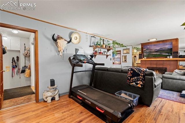 1514 Howard Ave, Colorado Springs, CO 80909 - exercise room with wood finished floors and a brick fireplace