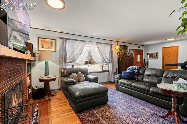 1514 Howard Ave, Colorado Springs, CO 80909 - living area with a brick fireplace and wood finished floors