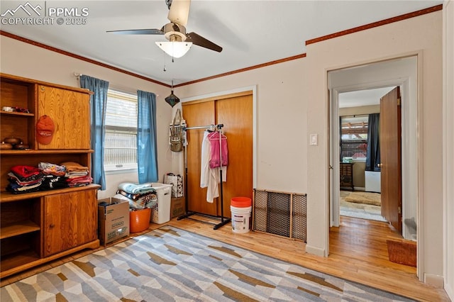 1514 Howard Ave, Colorado Springs, CO 80909 - bedroom featuring light wood-style flooring, a closet, a ceiling fan, and multiple windows